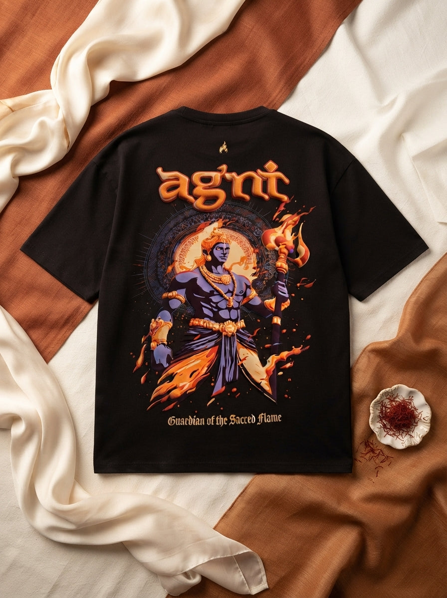 Close-up flat-lay of a premium oversized T-shirt with a textured puff-print graphic, displayed on a warm cream and sienna bac